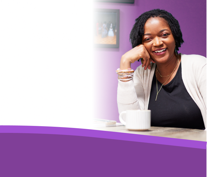 UPLIZNA NMOSD hero header image: A real NMOSD patient, Esther, smiles directly at the camera