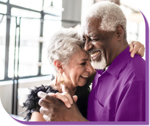 Sign Up to Learn More hero header image: Man and woman laughing while dancing