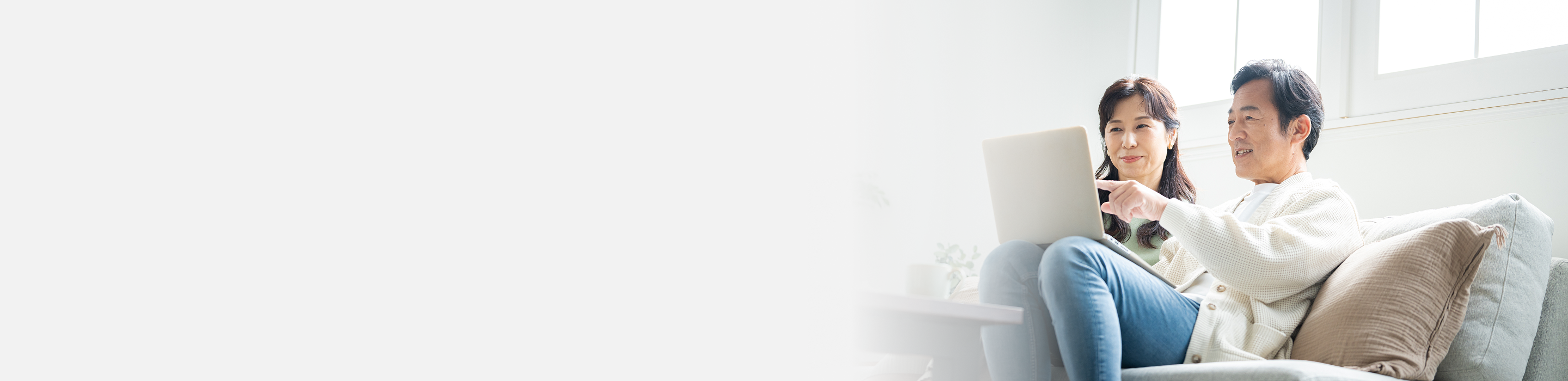 Page header image of UPLIZNA® patients sitting on the couch looking at a laptop